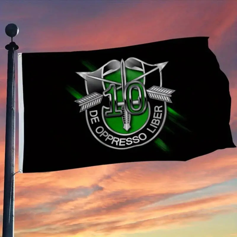 10th Special Forces Flag with green emblem and silver arrows flying against sunset sky