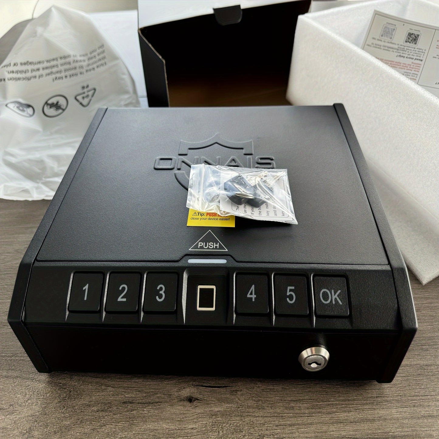 Military-Outdoors.com biometric gun safe for pistols with keypad and fingerprint scanner on wooden surface