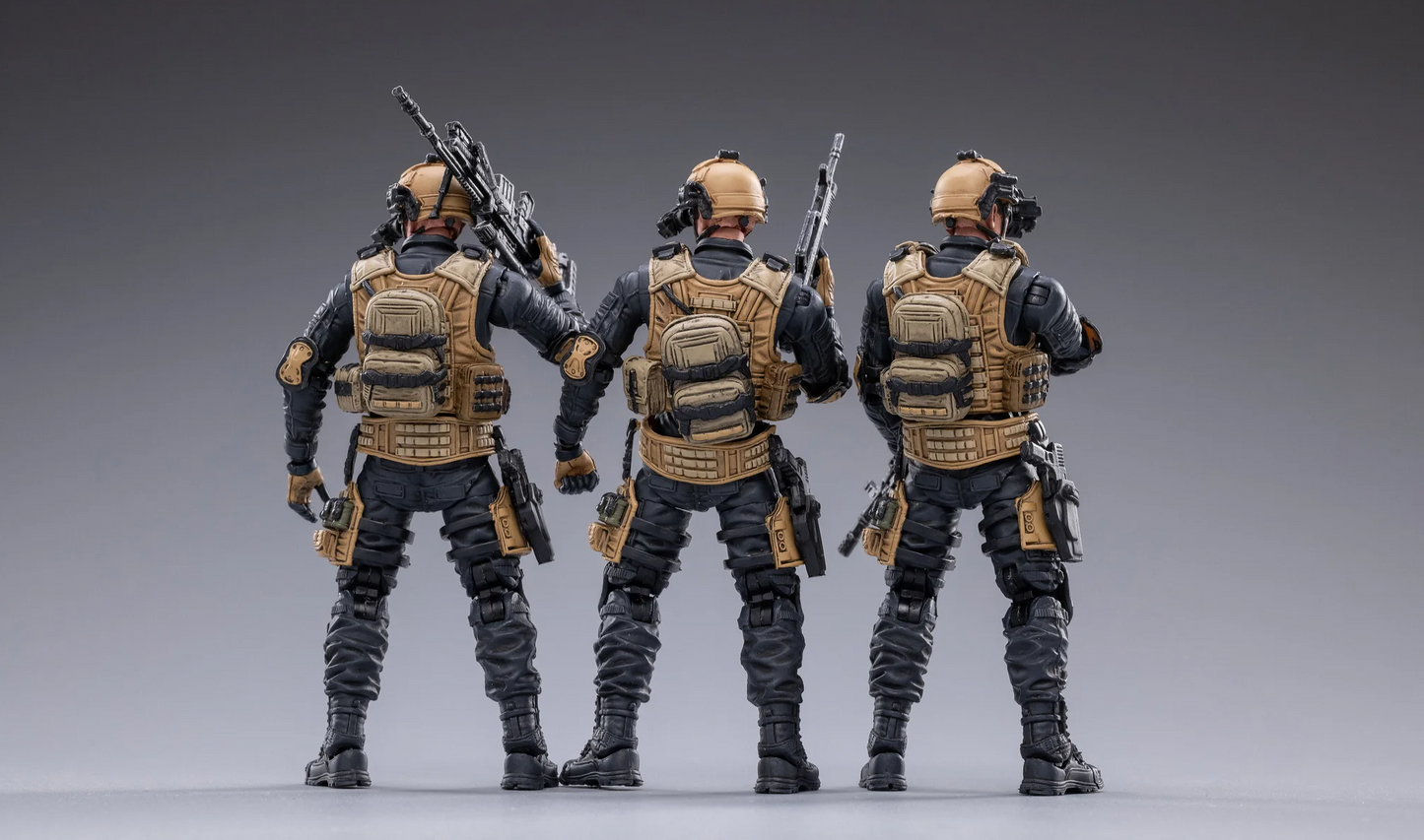 Rear view of JOYTOY special forces set action figures in tactical gear holding rifles