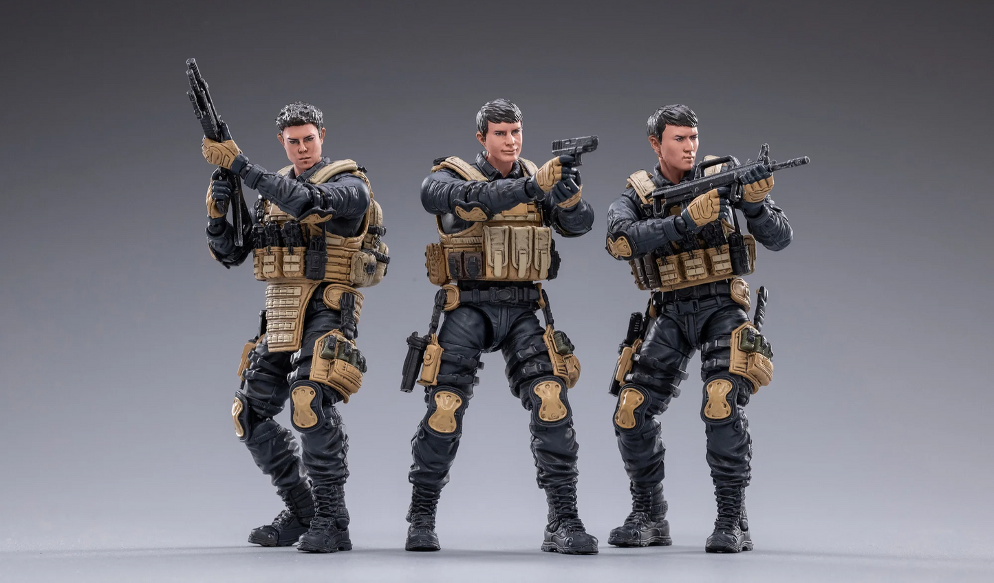 Three detailed action figures from the JOYTOY special forces set in tactical gear with weapons