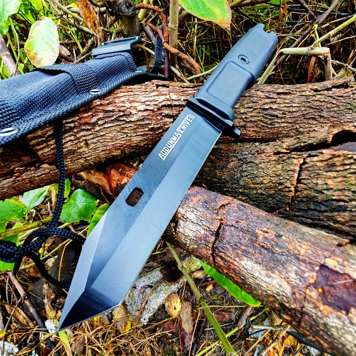 Military-Outdoors.com wilderness survival multi-purpose knife black tanto blade with nylon sheath on forest logs