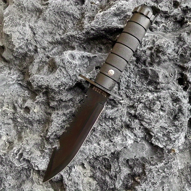 Black hunting and camping knife with textured handle on gray rocky surface from Military-Outdoors.com