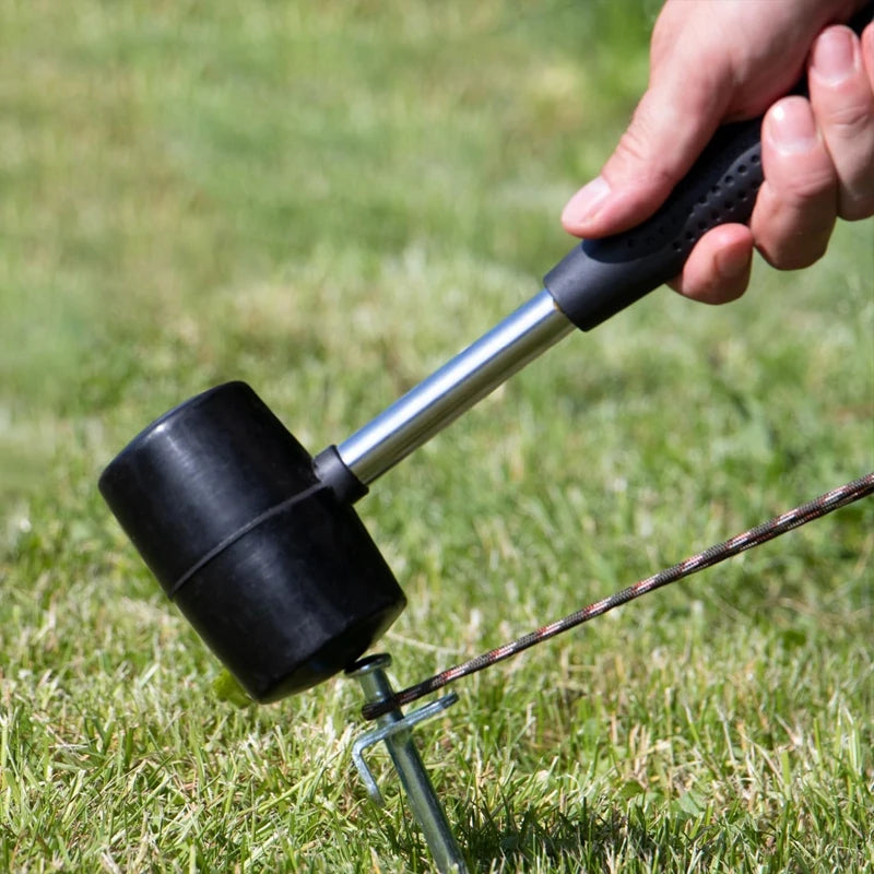Rubber mallet hammer used for securing tent stakes into grass for outdoor activities