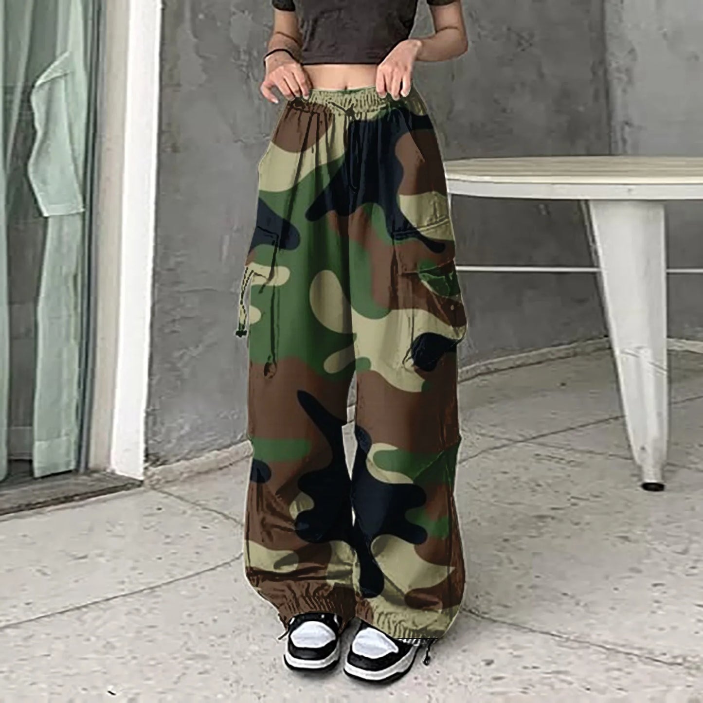 Women's vintage camouflage cargo pants with elastic waistband and ankle cuffs styled with black crop top