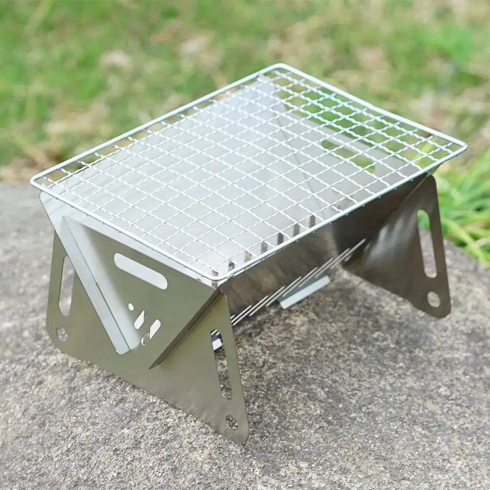 Military Outdoors stainless steel portable folding grill with wire cooking grate and foldable legs for camping