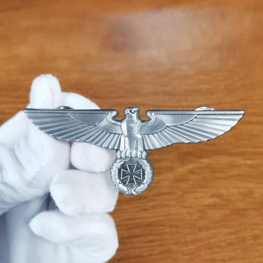 Close-up of a German Army Eagle Badge with detailed eagle design on a wooden background
