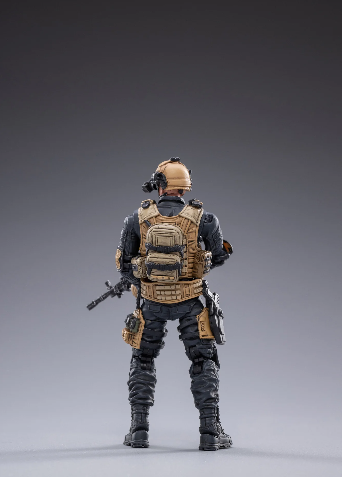 Back view of JOYTOY special forces set action figure in tactical gear holding a rifle
