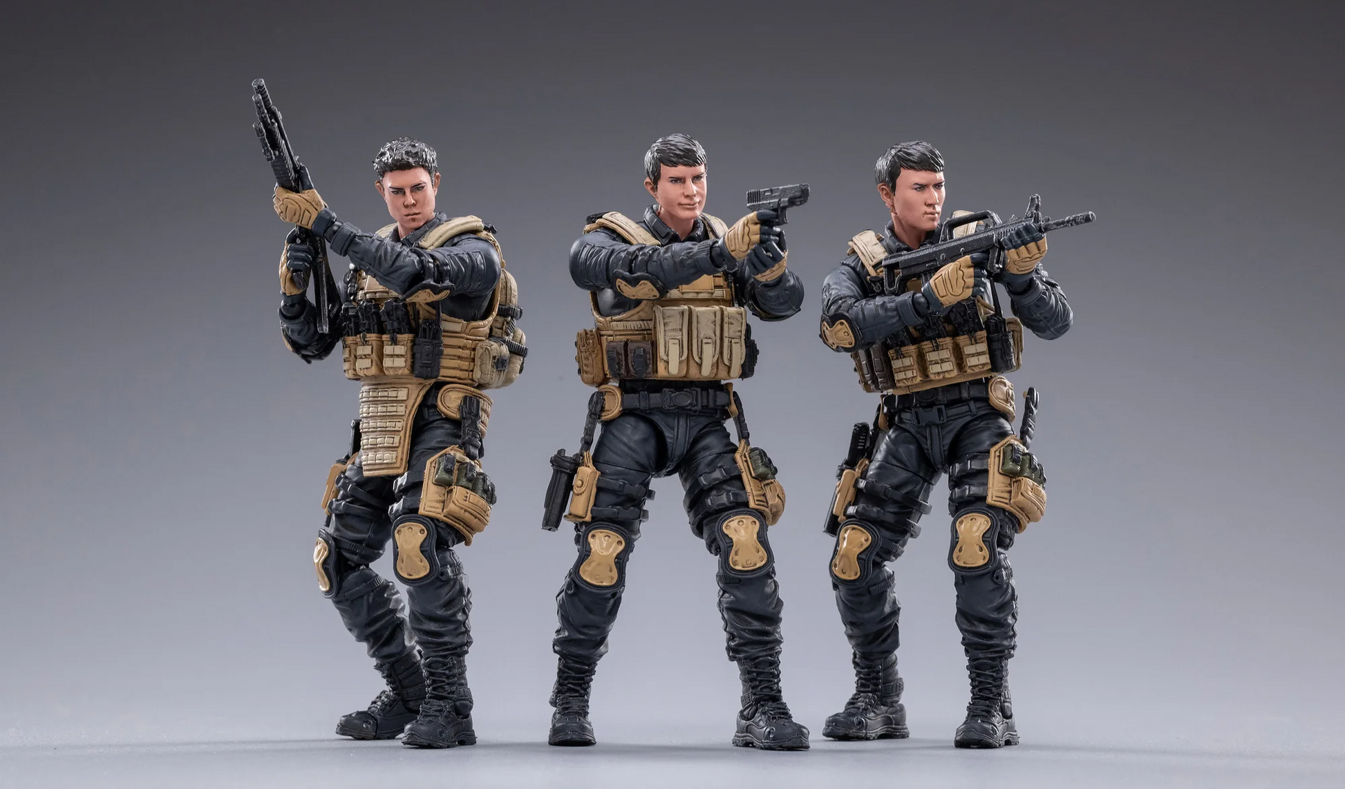 Three detailed action figures from the JOYTOY special forces set in tactical gear with weapons