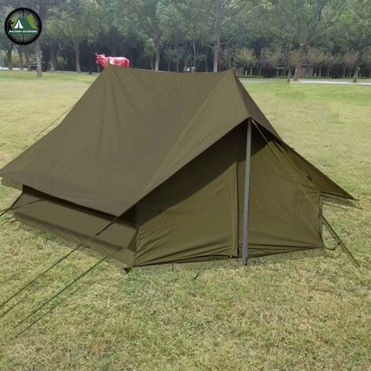 Military Outdoors olive drab canvas military camping tent A frame with center pole and guy lines on grass